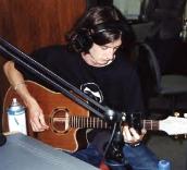 James attempts the slide guitar technique via coffee mug, Steadman in studio August 2000